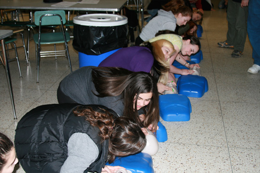 Girls practicing cpr, girls in cpr training, girls with cpr dummies, teenage girls in cpr training, Teens For Life in training